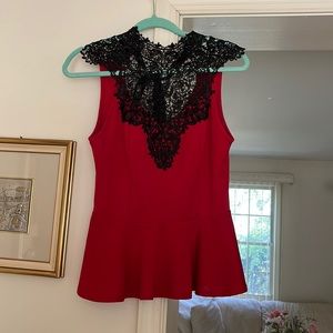 Cherry red top with black lace neckline and satin tie at the neck